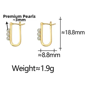 Detailed view of U-shaped gold earrings featuring three 3mm high-quality pearls