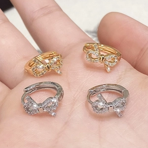 Bowtie hoop earrings with micro-paved zircons in gold and silver plating on palm