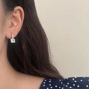 Elegant silver earrings with square zircon stone and micro-pave diamonds on model