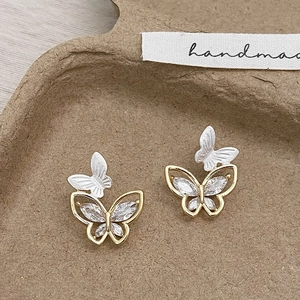 Minimalist butterfly stud earrings with silver relief and gold-tone zircon inlay