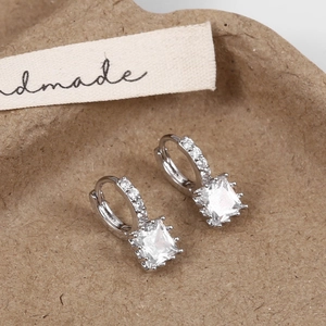 Macro view of silver hoop earrings with square cubic zirconia drop and micro-pave setting