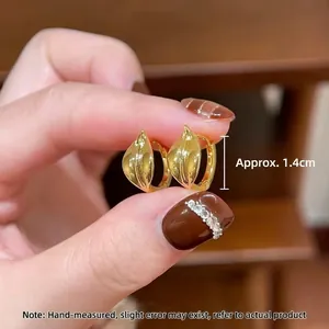 Elegant gold leaf-shaped hoop earrings with a streamlined minimalist metal design