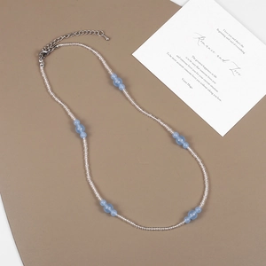 Detail of beaded necklace with light blue stones and adjustable metal lobster clasp