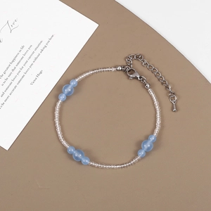 Detail of light blue matte beads necklace with silver adjustable chain and lobster clasp