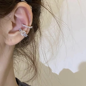 Close-up of silver ear cuff set with square and row zircon stones for non-pierced ears