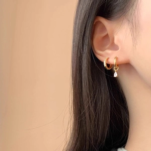 Asymmetric gold hoop earrings with micro-pave stones and a pear-cut zircon drop pendant