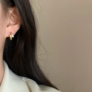 French vintage gold lightning stud earrings with sparkling pavé crystals worn on model