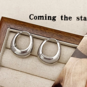 Minimalist silver U-shaped hoop earrings with polished finish in a premium jewelry box