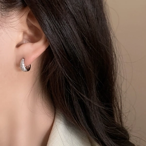 Minimalist silver micro-pave cubic zirconia hoop earrings shown worn on ear