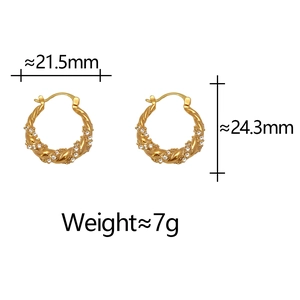Detailed view of twisted gold hoop earrings with dimensions 21.5mm width and 24.3mm height