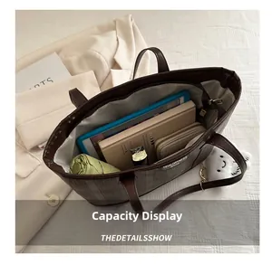 Detail view of large dark brown tote bag interior showing ample storage for a tablet