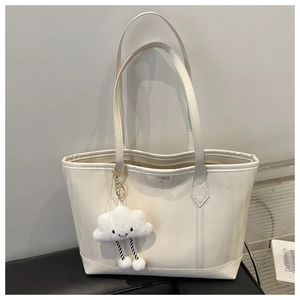 Cream white textured leather tote bag with vertical stripes and cloud plush charm accessory