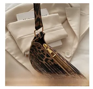 Close-up of leopard print shoulder bag featuring a premium gold zipper and smooth texture