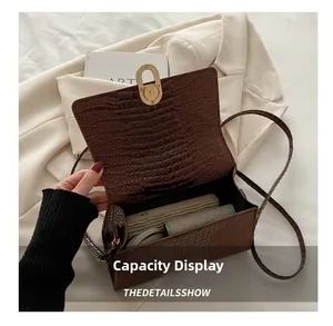 Detail shot of the brown crocodile pattern bag showing spacious interior for essentials