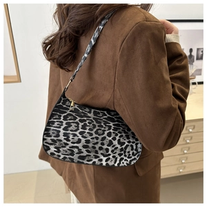 Fashionable leopard print hobo bag worn by a model in a minimalist interior setting