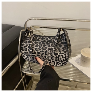 Close-up of hobo bag with black and white leopard print and gold metal buckle detail