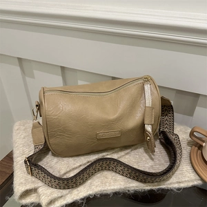 Retro khaki cylindrical crossbody bag with geometric wide strap and fashion label