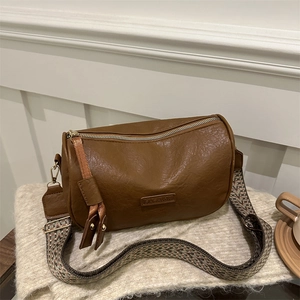 Retro brown crossbody bag with lychee texture and colorful bohemian woven strap