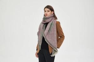 Detailed texture of thick knit shawl scarf with retro floral pattern and fringed edges