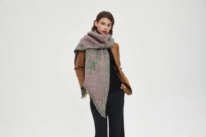 Close-up of thick knit shawl with Morandi purple and green patterns and fringe details