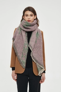 Close-up of thick knit winter scarf featuring purple geometric patterns and fringe detail