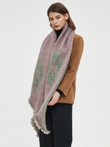 Detailed view of thick taro purple scarf with green floral patterns and fringe