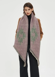 Close-up of thick retro burgundy scarf with green geometric patterns and frayed edges