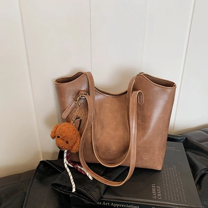 Retro brown leather tote bag with long straps and cute bear charm for daily commute