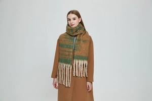 Detailed texture of thick jacquard gradient scarf with soft chunky tassels in winter