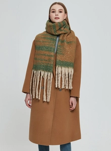 Close-up of thick green and brown striped jacquard scarf with long white tassels