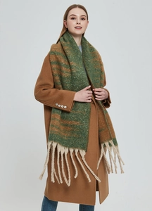 Detail of thick boucle knit scarf with green and brown stripes and long chunky tassels