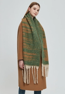 Detail of chunky knit scarf with green and brown stripes and long cream white tassels