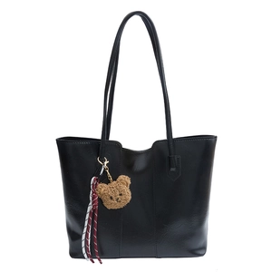 Classic black high-capacity tote bag with shiny leather texture and cute plush bear charm