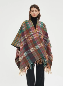 Detail of colorful zigzag knit shawl with bohemian tassels and premium fringe finish