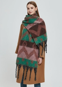 Detail of thick winter knit scarf with colorful heart jacquard pattern and black tassels