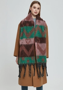 Detail of winter thick knit scarf showing pink heart jacquard patterns and black tassels