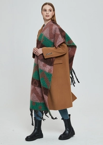 Detail of winter thick jacquard scarf with geometric color blocks and long black fringe