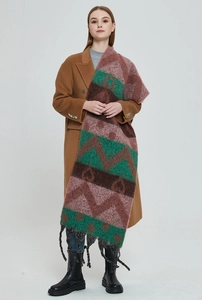 Close-up of thick geometric knit scarf with colorful heart patterns and fringed edges