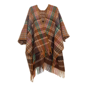 Detail of bohemian knit shawl featuring colorful zigzag patterns and fringe trim