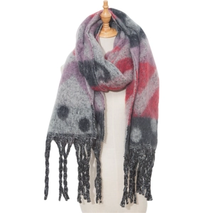 Detail of winter scarf featuring red and purple geometric plaid pattern with long tassels