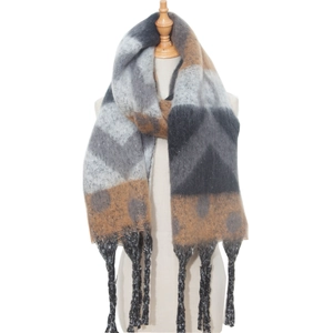 Close-up of winter thick knit scarf with geometric color blocks and long fringe details