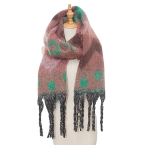 Detail of pink knitted scarf with green dots and dark grey tassel texture for winter