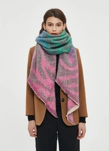 Detail of zebra-patterned jacquard scarf with gradient colors and fringed edges