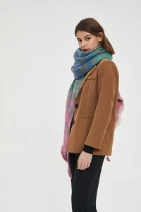 Multi-color plaid scarf with fringes styled with a brown blazer for autumn and winter outfits