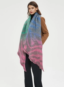 Close-up of soft knit scarf with vibrant abstract zebra print and delicate fringe edges