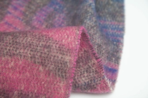 Detailed texture of zebra jacquard knit scarf with soft pink and grey brushed finish