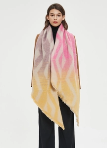 Close-up of geometric jacquard pattern and soft fringe on the pink thick shawl scarf