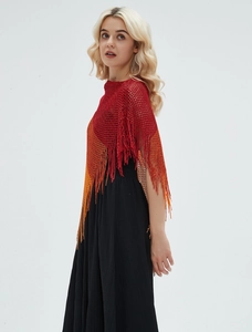Detailed texture of red-orange gradient knit shawl with delicate fringe and mesh pattern