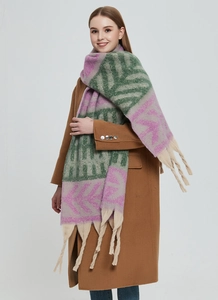 Detailed view of thick leaf jacquard scarf with long beige tassels and green purple pattern