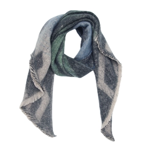Detail view of thick geometric knit scarf with fringe trim and dark grey textures